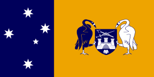 Left third: White stars of the Southern Cross on blue field.  Right two-thirds; black and white swans holding a blue shield with a white castle above a white flower and below a sword and scepter arranged in an "X" formation with a white crown superimposed, all on a yellow field.