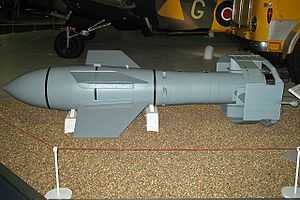 A grey missile sitting on a light-colored floor