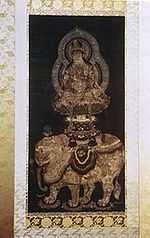 Side view of a deity seated on a pedestal on top of a white elephant.