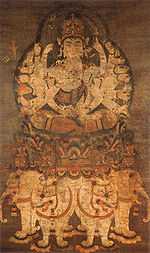 Deity with many arms seated on a pedestal on top of four white elephants.