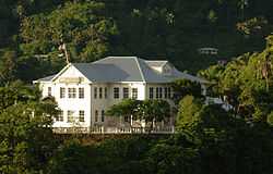 Photograph of a two-story, white building on a ridgetop