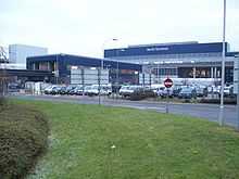 Blue-and-grey terminal building and parking lot