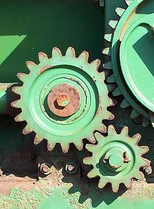 Part of a machine with three gears connected to one another.