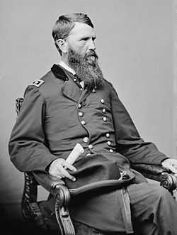 Seated man with beard in uniform