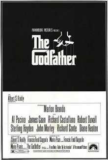 The Godfather written on a black background in stylized white lettering, above it a hand holds puppet strings.