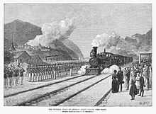 Drawing of steam engine and train approaching station with an honor guard at attention