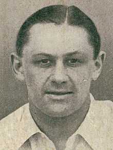 Headshot of a man in a white shirt