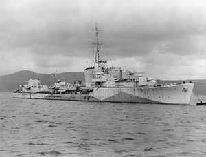 a black and white photograph of a warship at sea