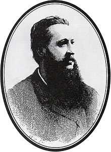 head and shoulders shot of a middle-aged man with a beard looking to the right