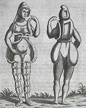 A front and back illustration of a Renaissance-era hermaphrodite showing a person with female facial features, breasts, and what appears to be a small penis or large clitoris. She wears a small hood and open robe tied multiple times around the legs. Where it opens in the front, the apparent rear appearance shows it to be perhaps a shell of some kind, as one with her body Two squares are missing from her the back of her head and torso. She has no buttocks.