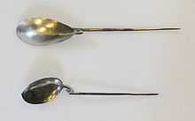 Two long-handled spoons, the "handle" being a tapering metal spike