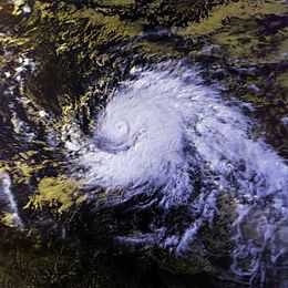 Satellite image of a large, mature hurricane. The structure of the storm is similar to the number "9", with a single, large rainband curving into the center. At the center, there is a small, well-defined eye.