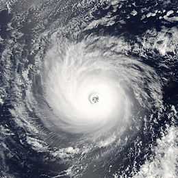 A view of a hurricane over open waters from Space. The hurricane is well-developed, with a symmetric cloud pattern and a well-defined eye at the center.