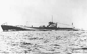 A large submarine underway. Japanese flags and the number "176" are painted on the fin.