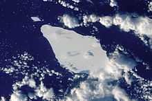 Overhead photo of iceberg with surrounding clouds