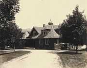 A shingled two-story building and driveway