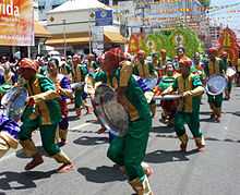 Street dancers, dressed in green and red