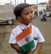  A child holding a small sized flag