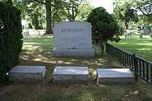Three Robinson family gravestones are placed next to a larger family headstone with the quotation "A life is not important except in the impact it has on other lives," inscribed with Robinson's signature