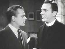 Head and shoulders shot of Cagney talking to a man in a clerical collar.