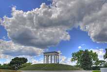 Six white columns atop a hill