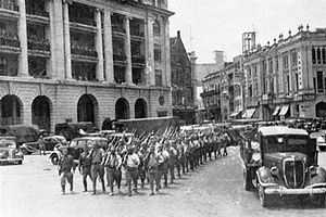 A parade of Japanese soldiers in a street of Singapore