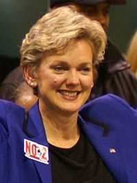 A middle-aged woman with blond hair, smiling