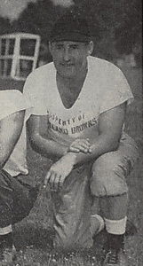 A picture of John Brickels kneeling on the grass from a 1946 Cleveland Browns game program