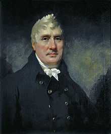 Portrait of male with white hair wearing a white cravat and blue jacket.