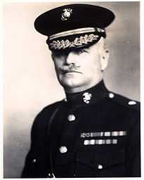 A black and white image of John Myers, a white male in his Marine Corps dress blue uniform. He has a moustache, is wearing a hat and several ribbons are visible.