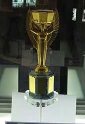 Golden trophy in a presentation case. It depicts the Greek goddess Nike standing with arms aloft.