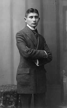 Black-and-white photograph of Kafka as a young man with dark hair in a formal suit