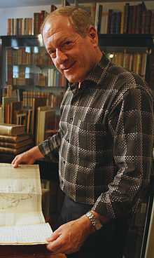 Picture of Kenneth Karmiole holding a book.