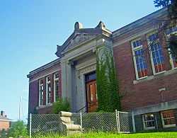 Front view of library showing main entrance, front facade and fencing