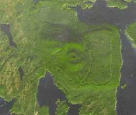 A landmass engulfed by portions of water with a circular feature in the middle