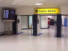 Three doorways, with gate numbers and large flight screen