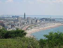 A distant view of a large city bordered by a beach.