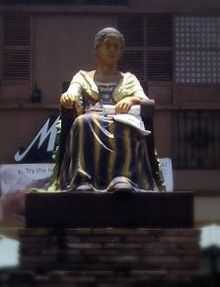 A statue of a sitting woman