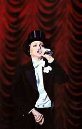 Madonna wearing a tuxedo and hat