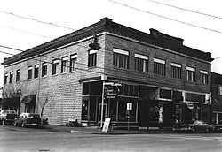 Photograph of the Lumber Exchange Building, a two-story commercial building on a city street corner