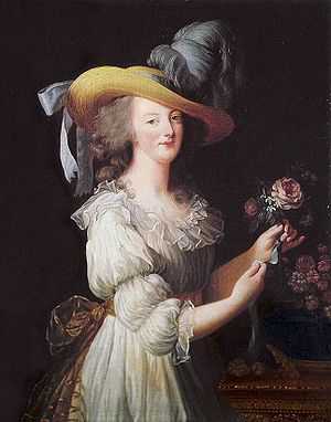 Three-quarter length portrait of a woman wearing a large straw hat with grayish-blue ostrich feathers and a ruffly cream dress with a gold bow tied at the waist in the back. She is arranging a group of pink flowers.