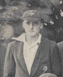 A man in a cricket cap and blazer