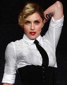 A blond woman wearing a white shirt and black necktie