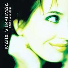 The cover artwork shows only an a bit obscure picture of a face of a woman approximately at the age between 20 and 30 with short, apparently black hair. The smiling face with closed mouth, turned half-way to the left, and the woman's right hand in a fist placed to support her jaw, are exposed to greenish, white light. Due to the angle of the face, the woman's right eye is not visible. On the right side of the picture is a dark space with the vertical, bottom-to-the-top capital script which reads "Maija Vilkkumaa" on the upper row and "Pitkä ihana leikki" on the lower row, with both rows written in capital letters.