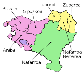The seven provinces of the Basque Country, as claimed by certain Basque sectors, span France (light yellow) and Spain (rest of the map). The enclaves of Valle de Villaverde and Treviño are pictured in red and blue, respectively. Names on this map are in Basque.