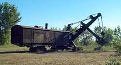 The same rusted steamshovel seen in the above picture, with the vegetation around mowed so that its lower section is visible