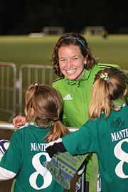 Photo of a smiling woman wearing a green jacket.