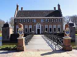 Brick building surrounded by a moat with a bridge