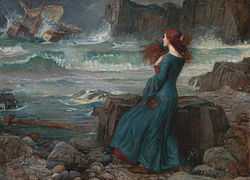 A woman with long reddish hair in a long dark dress, standing on a rocky shore, watching a storm at sea.