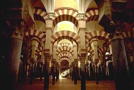 Inside of a mosque, with archways and pillars